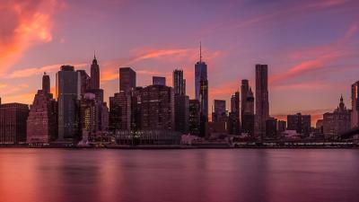 New York City skyline against orange sunset